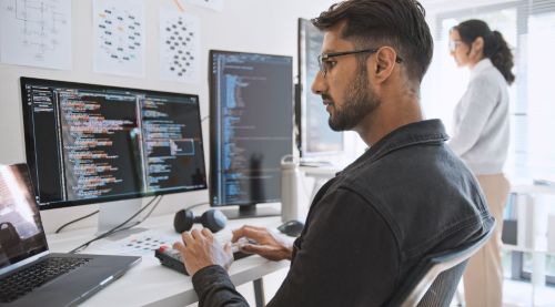 Young AI engineer at a computer doing work