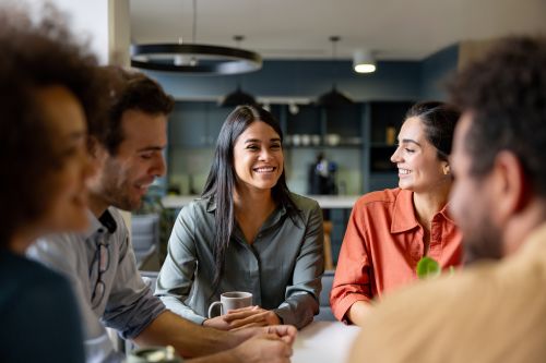 Professionals seated at a table who have either an MBA or and MPA degree